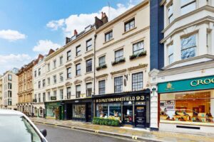 A row of London townhouses with shopfronts at street level