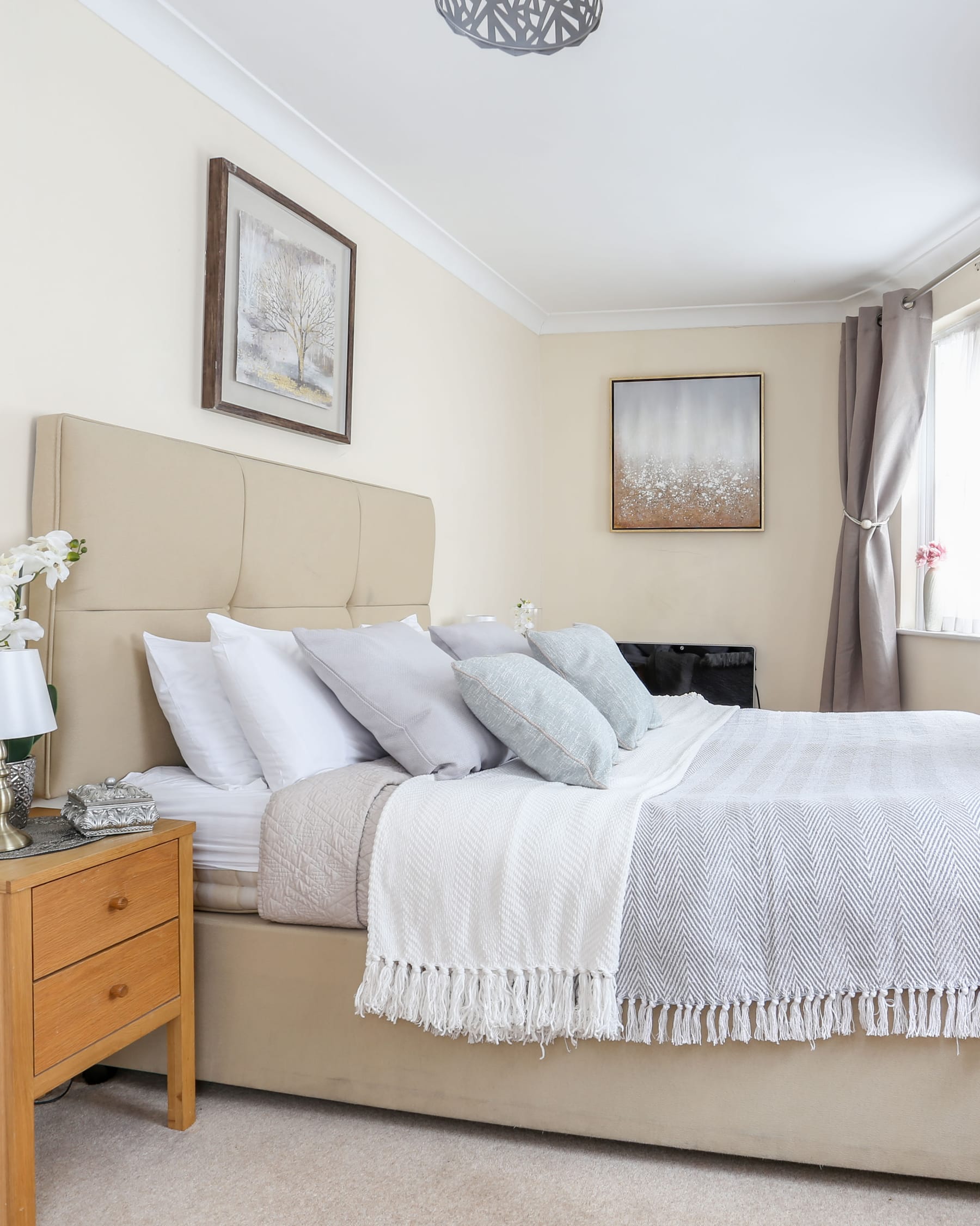 Bedroom at Clarges Street, Mayfair, with an upholstered headboard